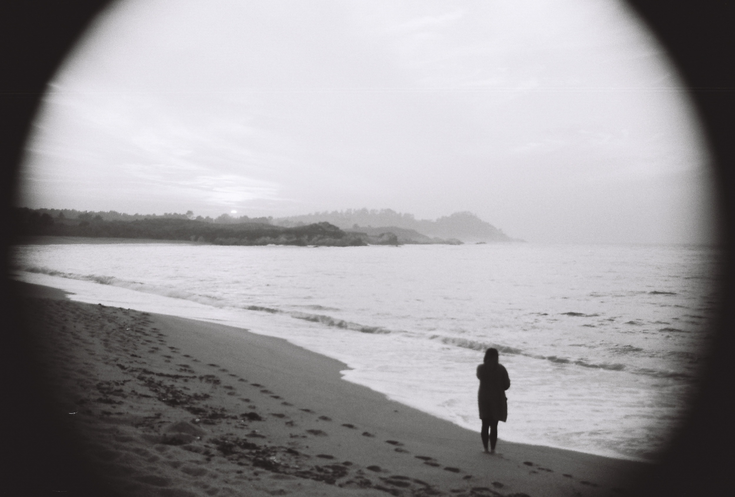 Coastline with a lone figure, 35mm black and white