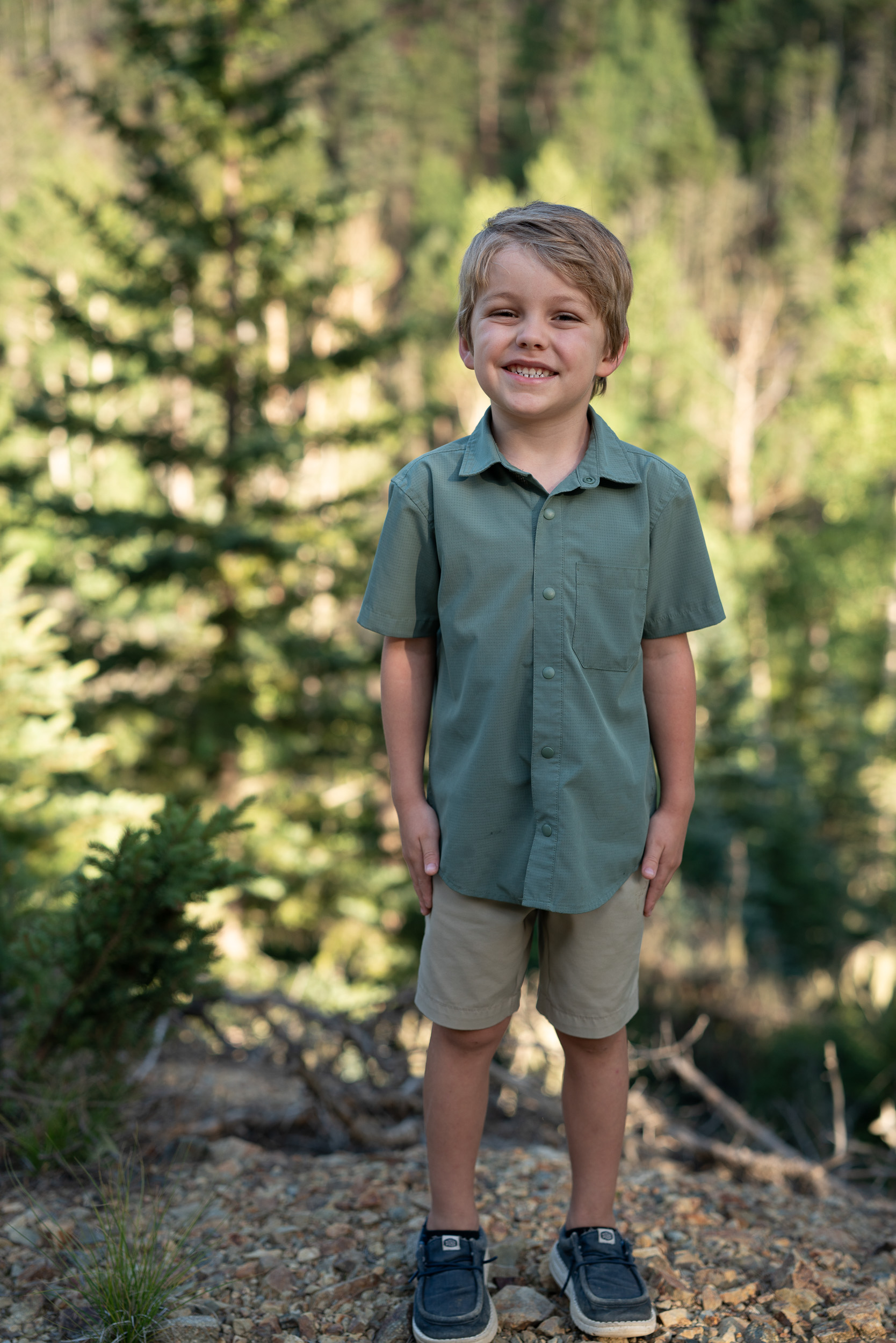 Boy standing in a forest