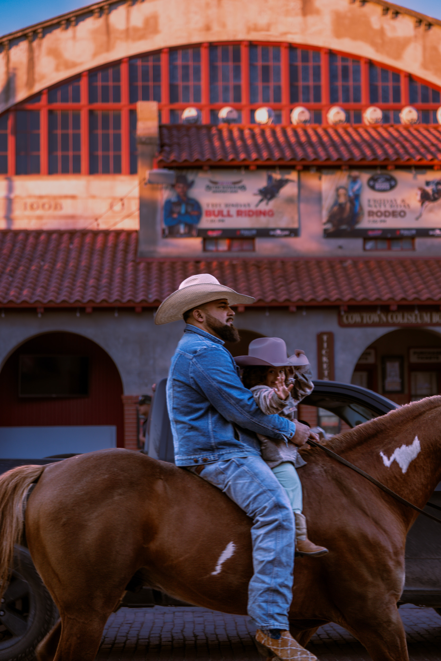 Man and young girl on horseback at the Stockyards